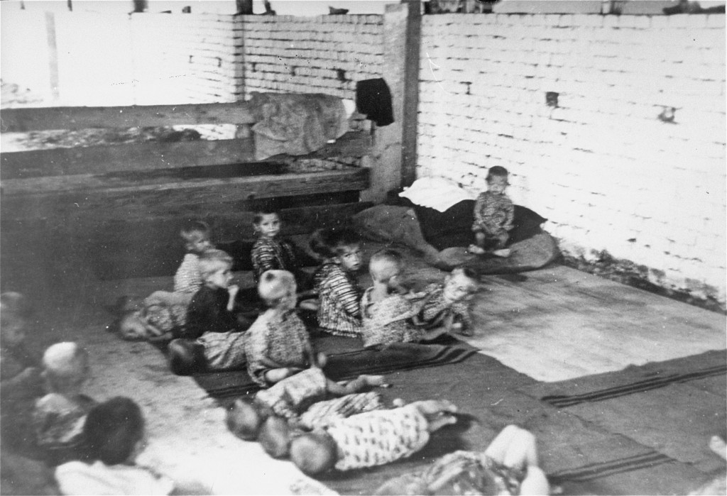 Children sit and sleep on the floor at Sisak, a Ustasa (Croatian fascist) concentration camp for children. [LCID: 85188]