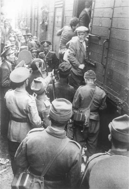Police force Romanian Jews, survivors of a pogrom in Iasi, to board a train during their expulsion from Iasi to Calarasi. [LCID: 67288]