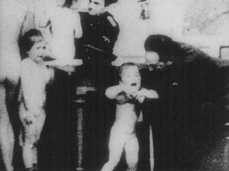 German officers examine Polish children to determine whether they qualify as "Aryan."