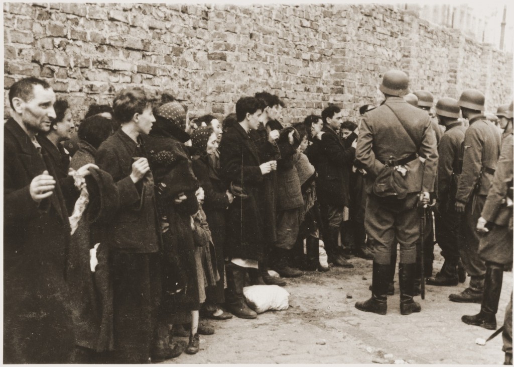 German soldiers interrogate Jews captured during the Warsaw ghetto uprising. [LCID: 46194]