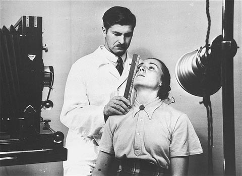 At the Kaiser Wilhelm Institute for Anthropology, Human Genetics, and Eugenics, a racial hygienist measures a woman's features in ... [LCID: 78569]