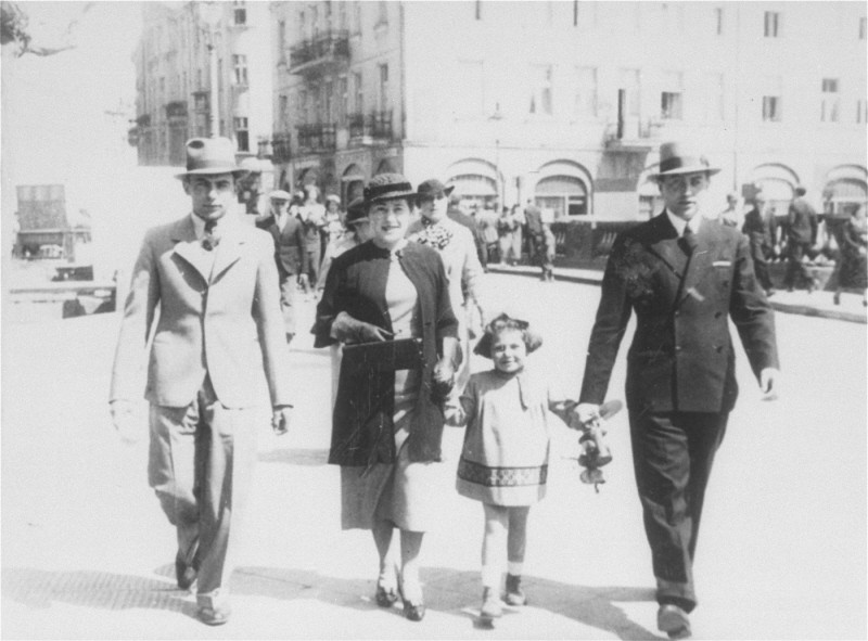 A Jewish family strolls along a street in prewar Kalisz. Poland, May 16, 1935.
