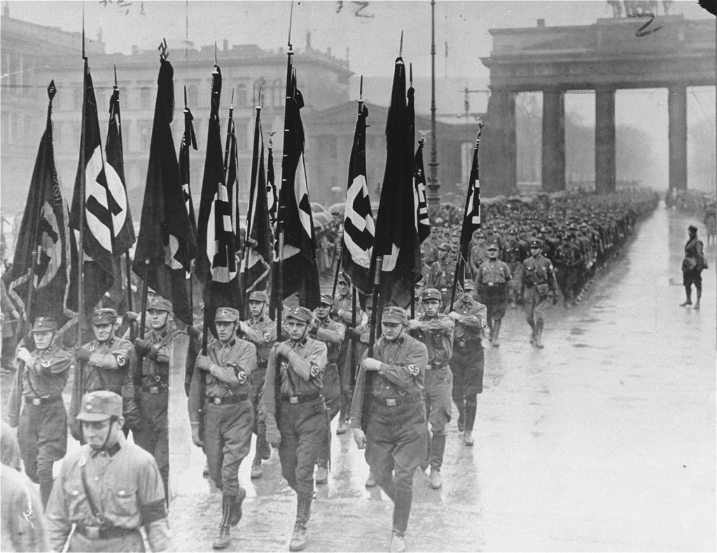 Members of the Storm Troopers (SA) march through the Brandenburg gate. [LCID: 87889]