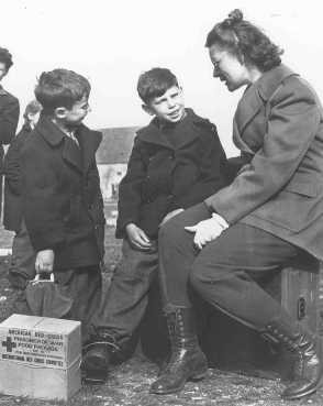 Jewish refugee children from Budapest talk to a worker from the United Nations Relief and Rehabilitation Administration.