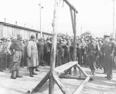 A Dutch survivor of the Ohrdruf camp shows the camp's gallows, which the Germans used to execute prisoners, to US forces (including ... [LCID: 74981]