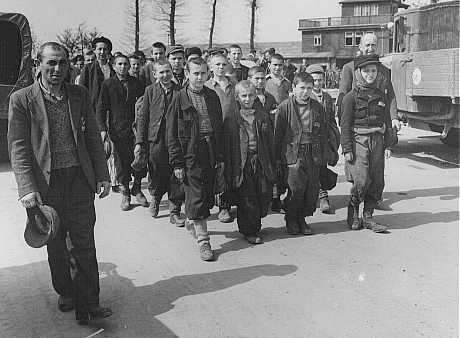 Children march out of Buchenwald to a nearby American field hospital where they will receive medical care. [LCID: 69225]
