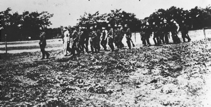 German soldiers lead blindfolded Polish hostages to an execution site.