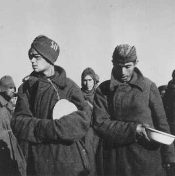 Soviet prisoners of war wait for food in Stalag (prison camp) 8C. [LCID: 50193]