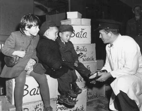 Jewish orphans fleeing Europe are fitted with shoes from the United Nations Relief and Rehabilitation Administration (UNRRA), en route to Allied occupation zones in Germany and Austria.