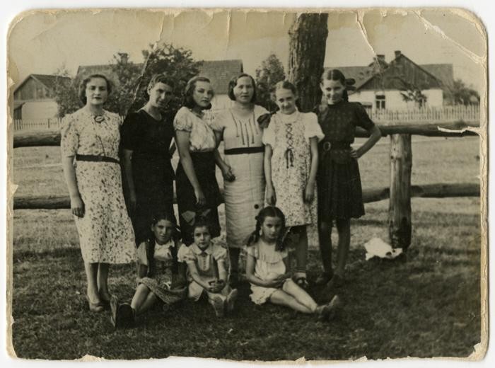 Group portrait of women and children standing outside in Warsaw before the war.