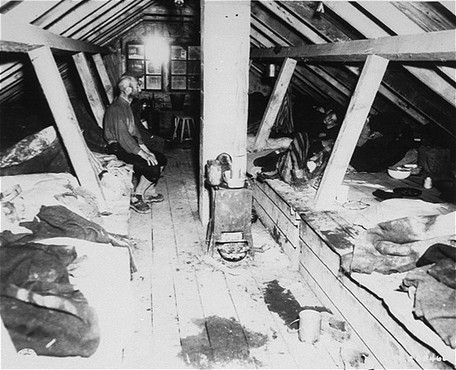 Camp forced laborers inside barracks soon after the liberation of Kaufering IV, part of a network of Dachau subcamps.
