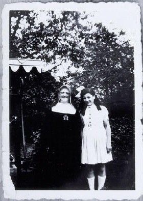 Augusta Feldhorn stands next to a nun while in hiding. [LCID: 58193]