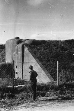 After the defeat of France, a German soldier examines French fortifications along the Maginot Line, a series of fortifications along the border with Germany.