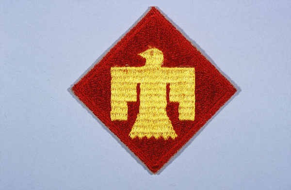 Insignia of the 45th Infantry Division. The 45th Infantry Division gained its nickname, "Thunderbird" division, from the gold thunderbird. [LCID: n05638]