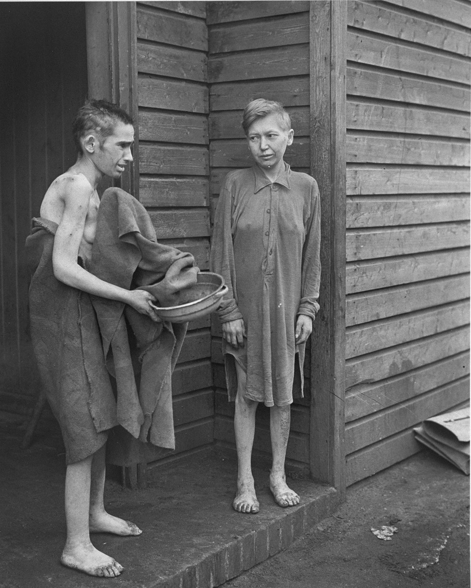 Two survivors in front of the women's barracks in the Bergen-Belsen concentration camp.