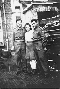 A Jewish Brigade soldier with two members of "Kibbutz Buchenwald," a group of survivors from the Buchenwald concentration camp preparing ... [LCID: 02274]