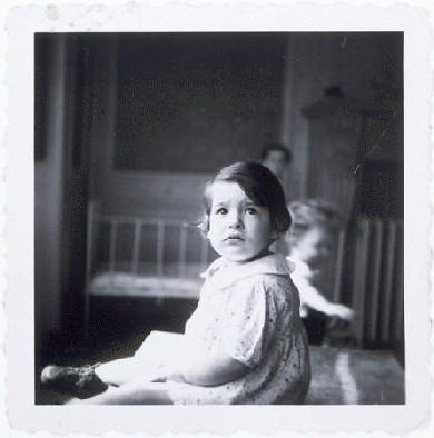 A young girl in a home for Jewish infants waiting for their families to claim them or be adopted. [LCID: 71594]
