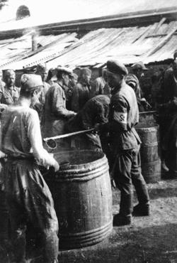 Soviet prisoners of war receiving their meager rations. [LCID: 50166]