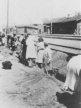 Jewish women deported from Bremen, Germany, are forced to dig a trench at the train station.
