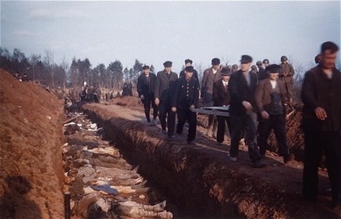 German civilians from the town of Nordhausen carry the bodies of prisoners found in the Nordhausen concentration camp to mass graves for burial.