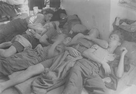 Jewish refugees, part of the Brihah movement (the postwar mass flight of Jews from eastern Europe), sleep on a crowded floor on the way to displaced persons camps in the American occupation zone.