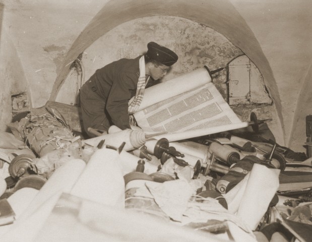 In the building of the former Nazi Institute for the Investigation of the Jewish Question, a US chaplain examines the Torah scrolls ... [LCID: 82978]