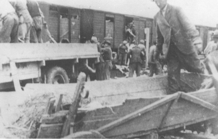 Roma (Gypsies) remove bodies from the Iasi-Calarasi death train during its stop in Tirgu-Frumos. [LCID: 27427]
