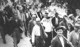 Jews drafted into the Hungarian Labor Service System march to a work site. Szeged, Hungary, between 1940 and 1944.