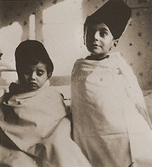 Tom (left) and Wolf Stein (right), dressed in Turkish-style costumes, attend a party celebrating the Jewish holiday of Purim. Hamburg, Germany, 1936.