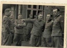 This photograph shows a group of SS officers at Solahuette, the SS retreat outside of Auschwitz. Pictured from left to right: Josef Kramer, Dr. Josef Mengele, Richard Baer, Karl Höcker, and an unidentified officer.