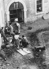 Preparation of food outside a barracks in Theresienstadt. Photograph taken after liberation. Theresienstadt, Czechoslovakia, June–August 1945. 
