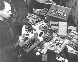 The valuables displayed here were confiscated from prisoners by German guards at the Buchenwald concentration camp and later found by soldiers of the Third US Army after the liberation of the camp. Buchenwald, Germany, after April 1945.