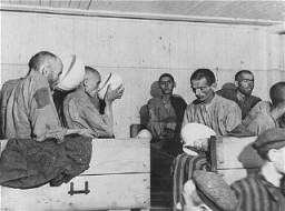 Liberated prisoners at the Ebensee camp. Too weak to eat solid food, they drink a thin soup prepared for them by the US Army. Photograph taken by US Army Signal Corps photographer J Malan Heslop. Austria, May 8, 1945.