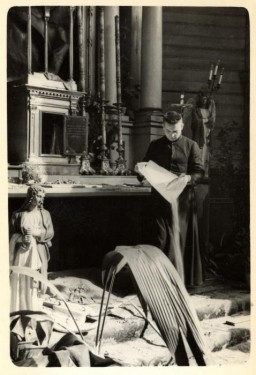 Father Wlodarczyk attempts to clean and repair a bombed-out church in the besieged city of Warsaw. Photographed by Julien Bryan, Warsaw, Poland, ca. 1939.