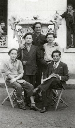 Group portrait at the Children's Aid Society (Oeuvre de Secours aux Enfants, OSE) home for Orthodox Jewish children in Ambloy, France. Among those pictured: Kalman Kalikstein (front left), Binem Wrzonski (middle right), and Elie Wiesel (back center). Photo dated 1945–1946.