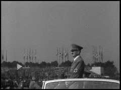 In the 1920s and 1930s, the German city of Nuremberg was host to massive and lavish rallies for the Nazi Party. This film footage, produced by Julien Bryan in 1937, shows saluting crowds in the Nuremberg stadium watching groups parade past Adolf Hitler.