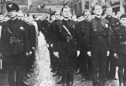 Belgian politician Léon Degrelle (center) stands in formation with fighters from the Belgian Volunteers who are on their way to fight in the Soviet Union. Belgium, August 15, 1941. During World War II, Degrelle founded a collaborationist military force that fought on the eastern front.
 