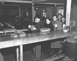 Jewish displaced persons receive food aid from the United Nations Relief and Rehabilitation Administration (UNRRA), at the Bindermichl displaced persons camp in the US zone. Linz, Austria, date uncertain.