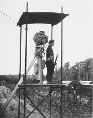 A British guard in a watchtower at Poppendorf displaced persons camp, after the arrival of Jewish refugees forced from the "Exodus 1947" refugee ship. Photograph taken by Henry Ries. Germany, September 1947.