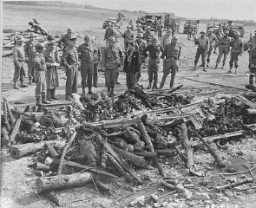 General Dwight D. Eisenhower (third from left) views the charred remains of inmates of the Ohrdruf camp. Ohrdruf, Germany, April 12, 1945.