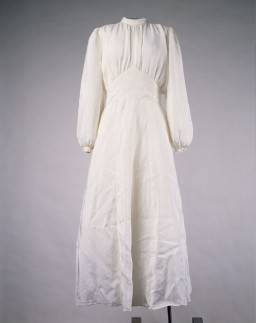 This wedding dress was made from a parachute and worn by Lilly Lax for her wedding to Ludwig Friedman in a displaced persons camp. Ludwig had promised to find fabric for a white gown, and purchased an old parachute for this purpose. Lilly hired a seamstress to make the dress in exchange for her cigarette ration. Other brides in the Celle and Belsen displaced persons camps subsequently wore the dress. Lilly and Ludwig immigrated to the United States in 1948.