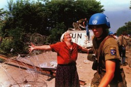 In July 1995, Bosnian Serb forces killed as many as 8,000 Bosniaks from Srebrenica. It was the largest massacre in Europe since the Holocaust. This photograph shows a Bosniak woman at a makeshift camp for people displaced from Srebrenica in July 1995.