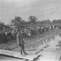 Romanian Jews assemble on the west bank of the Dniester River during deportation to Transnistria. Photo dated July 1941–June 1942.