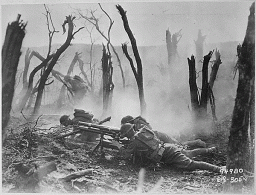 Surrounded by destruction, US soldiers of the 23rd Infantry fire a gun during World War I, 1918. 