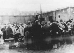 At the Jozsefvarosi train station in Budapest, Raoul Wallenberg (at right, with hands clasped behind his back) rescues Hungarian Jews from deportation by providing them with protective passes. Budapest, Hungary, 1944.