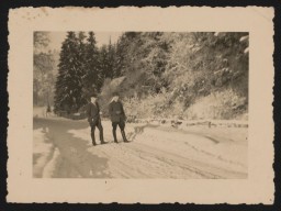 Johann Niemann (left) and an unidentified man walk on the snow covered driveway to Grafeneck Castle in early 1940. Niemann worked as a stoker at Grafeneck, cremating victims' corpses in the crematoria. He later became the deputy commander of the Sobibor killing center. 