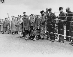 Soon after liberation, camp survivors wait for rations of potato soup. Bergen-Belsen, Germany, April 28, 1945.