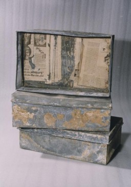 Three of the ten metal boxes in which portions of the Oneg Shabbat archive were hidden and buried in the Warsaw ghetto. The boxes are currently in the possession of the Jewish Historical Institute in Warsaw. In this view the three boxes are stacked on top of one another. The box on top is displayed on its side without the lid.
