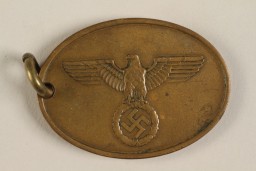 Official identification tag (warrant badge) for the Criminal Police (Kriminalpolizei or Kripo), the detective police force of Nazi Germany. These badges were generally suspended from a chain and included the officer's identification number on the reverse.