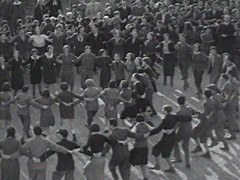 Zionist youth sing while dancing the hora, a folk dance.